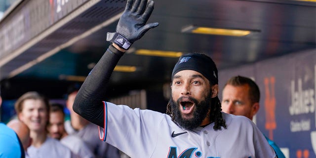Miami Marlins' Billy Hamilton celebrates after scoring off a throwing error by New York Mets catcher Tomas Nido during the tenth inning of a baseball game, Sunday, July 10, 2022, in New York.