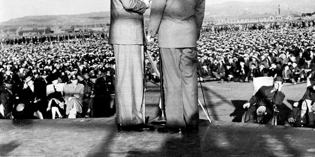 Entertainers Bob Hope and Bing Crosby perform on a USO (United Service Organizations) Tour in front of U.S. troops, circa 1942. 
