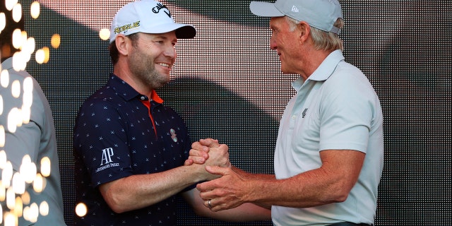 LIV Golf CEO Greg Norman, right, congratulates Branden Grace, winner of the Portland Invitational LIV Golf tournament in North Plains, Ore., Saturday, July 2, 2022.