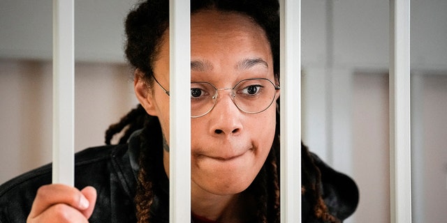 WNBA star and two-time Olympic gold medalist Brittney Griner speaks to her lawyers standing in a cage at a court room prior to a hearing, in Khimki just outside Moscow, Russia, July 26, 2022. 