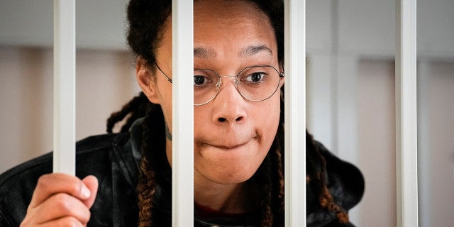 WNBA star and two-time Olympic gold medalist Brittney Griner speaks to her lawyers standing in a cage at a court room prior to a hearing, in Khimki just outside Moscow, Russia, July 26, 2022.