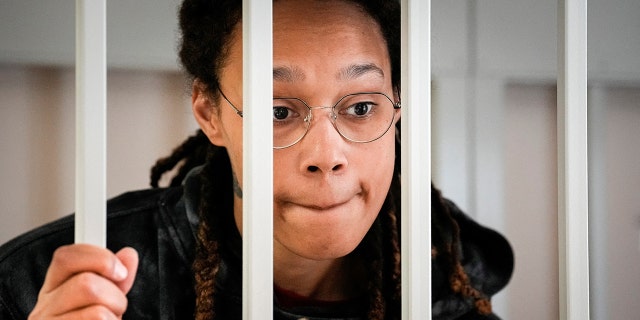 WNBA star and two-time Olympic gold medalist Brittney Griner speaks to her lawyers standing in a cage at a court room prior to a hearing, in Khimki just outside Moscow, Russia, July 26, 2022. 