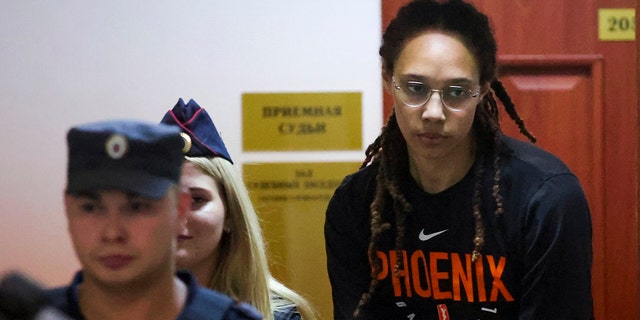 WNBA star and two-time Olympic gold medalist Brittney Griner is escorted to a courtroom for a hearing, in Khimki just outside Moscow, Russia, Wednesday, July 27, 2022.