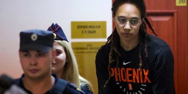 WNBA star and two-time Olympic gold medalist Brittney Griner is escorted to a courtroom for a hearing in Khimki just outside Moscow, Russia, Wednesday, July 27, 2022.