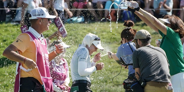 Brooke Henderson, of Canada, center, celebrates after winning the Evian Championship women's golf tournament in Evian, eastern France, Sunday, July 24, 2022.