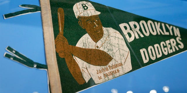 A banner with a picture of Brooklyn Dodgers baseball player Jackie Robinson is displayed at the exhibit 