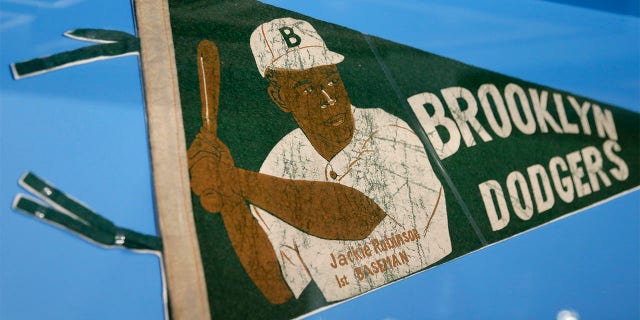 A banner with a picture of Brooklyn Dodgers baseball player Jackie Robinson is displayed at the exhibit