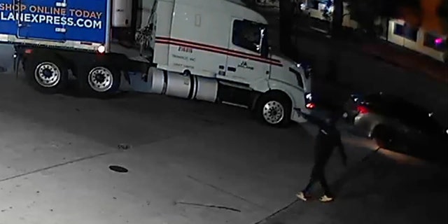 A screengrab from the video shows the gun wavering in his hand as he walks across the parking lot, right up to the victim.