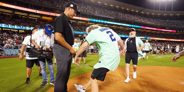 LOS ANGELES, CA - JULY 16:  Bryan Cranston kicks dirt on the umpire during the MGM All-Star Celebrity Softball Game at Dodger Stadium on Saturday, July 16, 2022 in Los Angeles, California. (Photo by Daniel Shirey/MLB Photos via Getty Images)