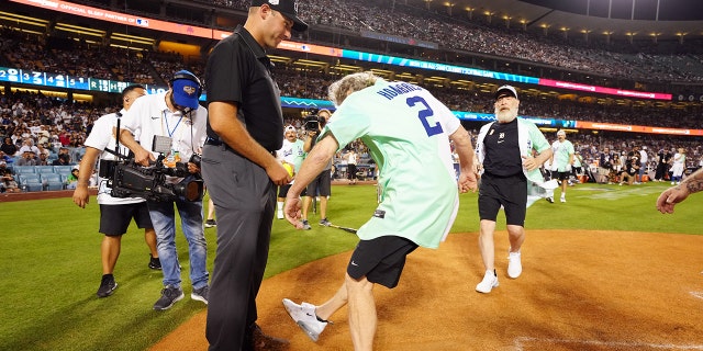 LOS ANGELES, CA - JULY 16:  Bryan Cranston kicks dirt on the umpire during the MGM All-Star Celebrity Softball Game at Dodger Stadium on Saturday, July 16, 2022 in Los Angeles, California. (Photo by Daniel Shirey/MLB Photos via Getty Images)