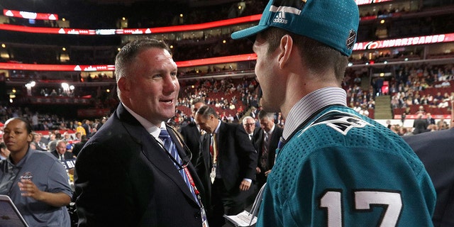 Scott Reedy, right, meets Bryan Marchment after being selected 102nd overall by the San Jose Sharks during the 2017 NHL Draft at United Center June 24, 2017, in Chicago.