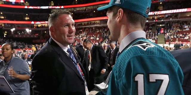 Scott Reedy, right, meets Bryan Marchment after being selected 102nd overall by the San Jose Sharks during the 2017 NHL Draft at United Center June 24, 2017, in Chicago.