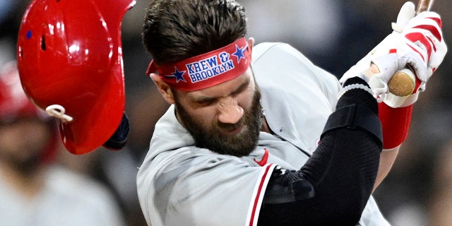 Bryce Harper #3 of the Philadelphia Phillies is hit with a pitch during the fourth inning of a baseball game against the San Diego Padres June 25, 2022 at Petco Park in San Diego, California.