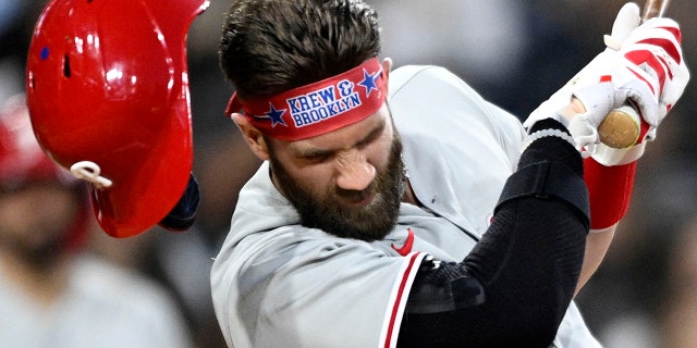 Bryce Harper #3 of the Philadelphia Phillies is struck off the pitch during the fourth inning of a baseball game against the San Diego Padres on June 25, 2022 at Petco Park in San Diego, California.