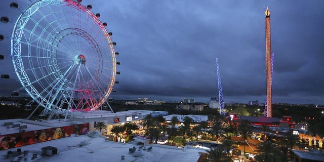 ICON Park attractions, The Wheel, left, Orlando SlingShot, middle, and Orlando FreeFall, right, are shown in Orlando, Fla., on March 24, 2022. 