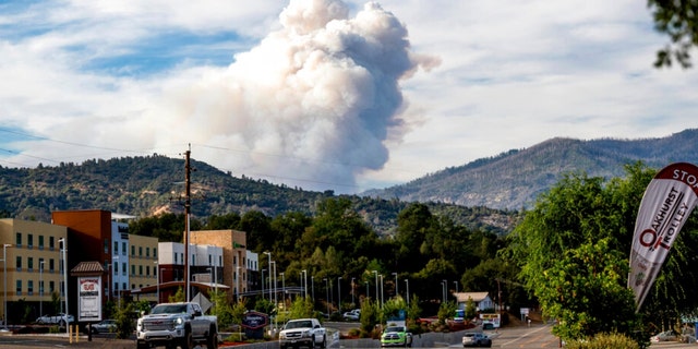 Viewed from Oakhurst in Madera County, Calif., a plume rises from the Washburn Fire burning in Yosemite National Park on Friday, July 8, 2022. 