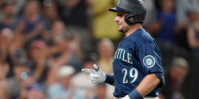 Seattle Mariners' Cal Raleigh reacts after crossing the plate after he hit a solo home run against the Texas Rangers during the seventh inning of a baseball game, Tuesday, July 26, 2022, in Seattle.