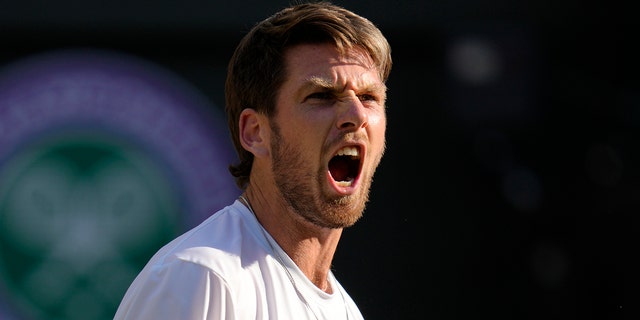 Britain's Cameron Norrie celebrates winning the men's singles quarterfinal match against Belgium's David Goffin at the Wimbledon tennis championships in London, Tuesday July 5, 2022. 