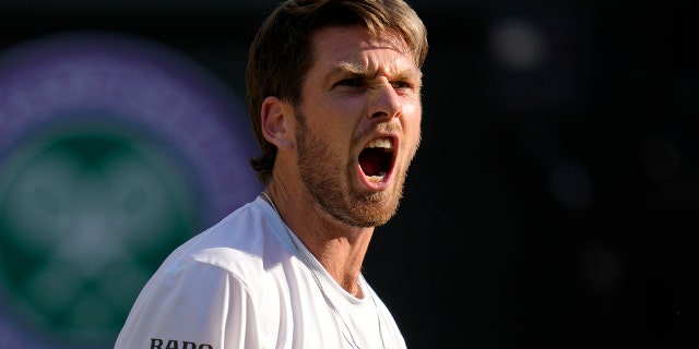 Britain's Cameron Norrie celebrates winning the men's singles quarterfinal match against Belgium's David Goffin at the Wimbledon tennis championships in London, Tuesday July 5, 2022.