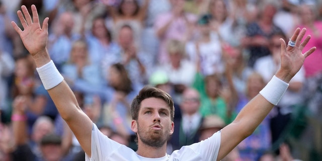 Britain's Cameron Norrie celebrates winning the men's singles quarterfinal match against Belgium's David Goffin at the Wimbledon tennis championships in London, Tuesday July 5, 2022. 