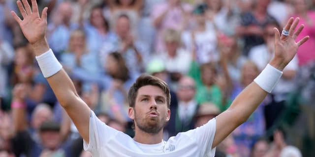 Britain's Cameron Norrie celebrates winning the men's singles quarterfinal match against Belgium's David Goffin at the Wimbledon tennis championships in London, Tuesday July 5, 2022.