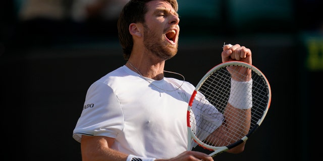 Britain's Cameron Norrie celebrates winning the men's singles quarterfinal match against Belgium's David Goffin at the Wimbledon tennis championships in London, Tuesday July 5, 2022.