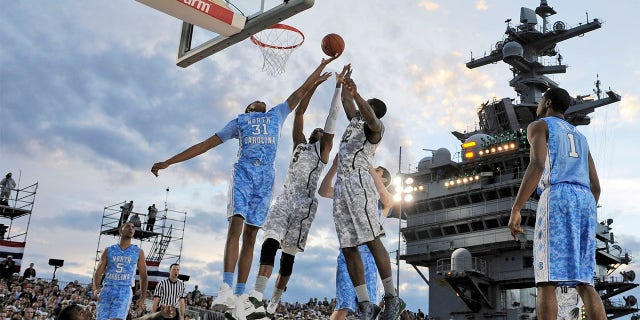 North Carolina forward John Henson (31) vies for a rebound with Michigan State center Adreian Payne (5) and forward Branden Dawson (22) during the first half of the Carrier Classic NCAA college basketball game aboard the USS Carl Vinson, Nov. 11, 2011, in Coronado, Calif.