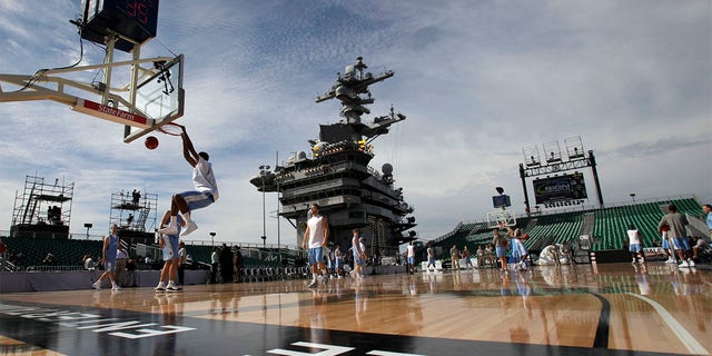 North Carolina forward Desmond Hubert, left, dunks during practice before the Carrier Classic NCAA college basketball game against Michigan State aboard the USS Carl Vinson, Friday, Nov. 11, 2011, in Coronado, Calif.