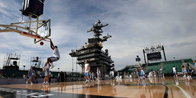 North Carolina forward Desmond Hubert, left, dunks during practice before the Carrier Classic NCAA college basketball game against Michigan State aboard the USS Carl Vinson, Friday, Nov. 11, 2011, in Coronado, Calif.