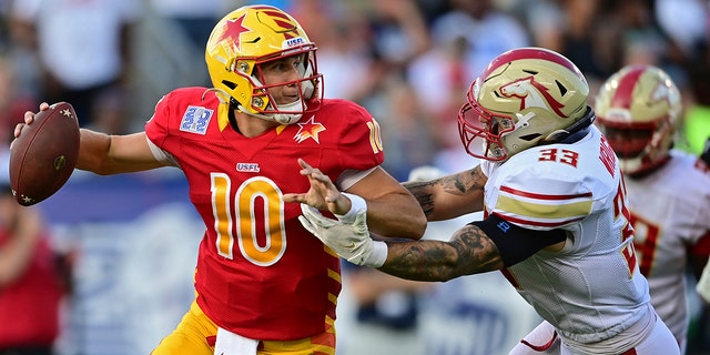 Philadelphia Stars quarterback Case Cookus (left) comes under pressure from the Birmingham Stallions inside linebacker Scooby Wright during the first half of a USFL league championship football game, Sunday, July.  February 3, 2022 in Canton, Ohio. 