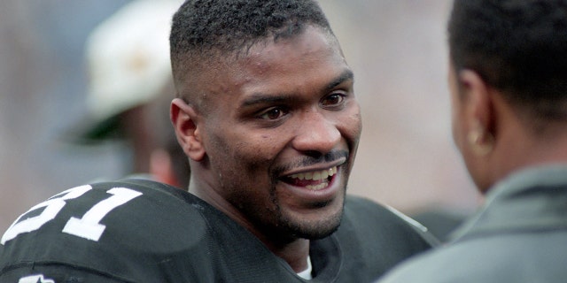 Steelers wide receiver Charles Johnson talks with injured teammate Yancey Thigpen during a playoff game against the Indianapolis Colts at Three Rivers Stadium on December 29, 1996, in Pittsburgh.