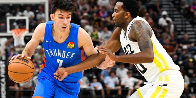 Chet Holmgren #7 of the Oklahoma City Thunder drives into Vic Law #70 of the Utah Jazz during a NBA Summer League game at Vivint Arena on July 05, 2022 in Salt Lake City, Utah.