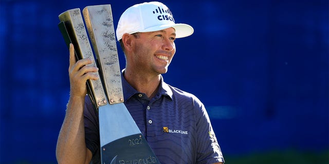 Chez Reavie of the United States poses with the trophy after putting in to win on the 18th green during the final round of the Barracuda Championship at Tahoe Mountain Club on July 17, 2022 in Truckee, California. 
