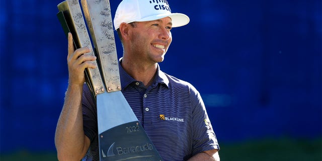 Chez Reavie of the United States poses with the trophy after putting in to win on the 18th green during the final round of the Barracuda Championship at Tahoe Mountain Club on July 17, 2022 in Truckee, California.