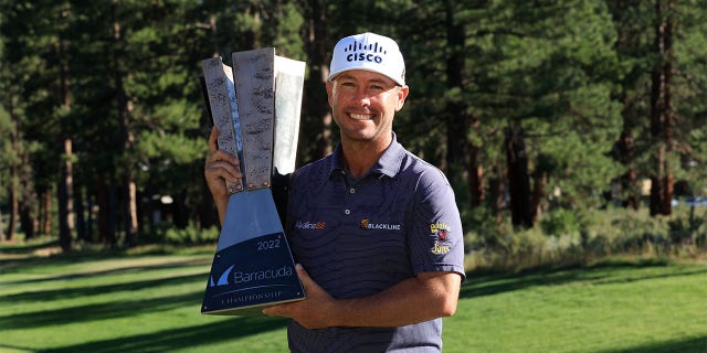 Chez Reavie of the United States poses with the trophy after putting in to win on the 18th green during the final round of the Barracuda Championship at Tahoe Mountain Club on July 17, 2022 in Truckee, California.