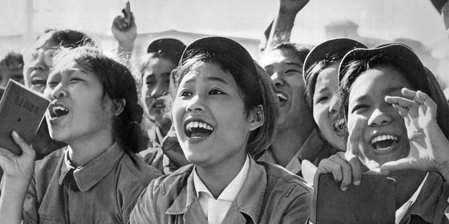 Members of red guards, holding The Little Red Book, cheering Mao Zedong during a meeting to celebrate the Cultural Revolution in 1966