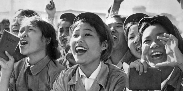 Members of red guards, holding The Little Red Book, cheering Mao Zedong during a meeting to celebrate the Cultural Revolution in 1966