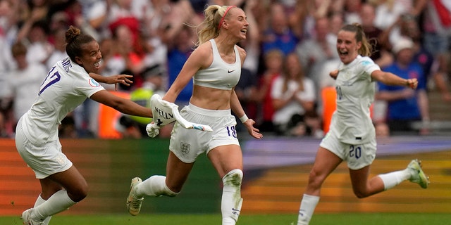 England's Chloe Kelly takes off her shirt as she celebrates her team's second goal during the Women's Euro final football match between England and Germany at Wembley Stadium in London, Sunday 31 July 2022.