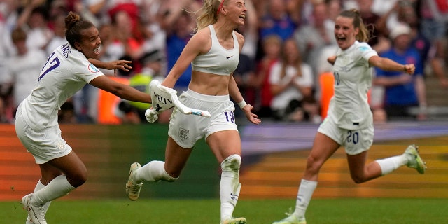 England's Chloe Kelly takes off her shirt as she celebrates her team's second goal during the Women's Euro final football match between England and Germany at Wembley Stadium in London, Sunday 31 July 2022.