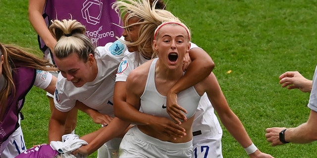 England's Chloe Kelly celebrates with teammates during the Women's Euro final between England and Germany in London, Sunday, July 31, 2022.