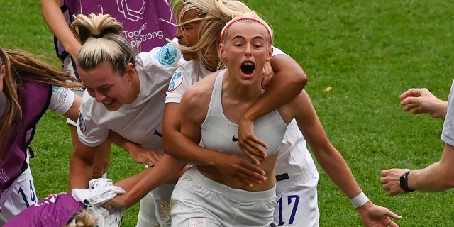 England's Chloe Kelly celebrates with teammates during the Women's Euro Final between England and Germany in London, Sunday 31 July 2022.