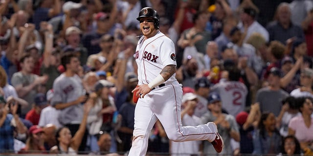 Boston Red Sox's Christian Vazquez celebrates as he arrives at home plate to score on a two-run home run hit by J.D. Martinez in the fifth inning of a baseball game against the New York Yankees, Sunday, July 10, 2022, in Boston. 