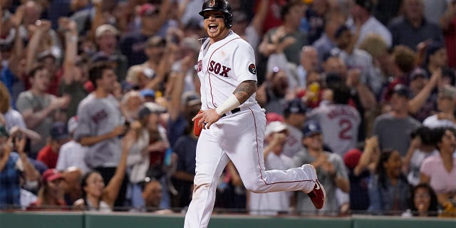 Boston Red Sox's Christian Vazquez celebrates as he arrives at home plate to score on a two-run home run hit by J.D. Martinez in the fifth inning of a baseball game against the New York Yankees, Sunday, July 10, 2022, in Boston.