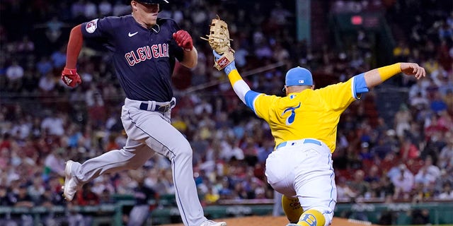 Cleveland Guardians' Myles Straw, left, grounds out to Boston Red Sox first baseman Christian Vazquez, right, during the eighth inning of a baseball game at Fenway Park, Tuesday, July 26, 2022, in Boston.