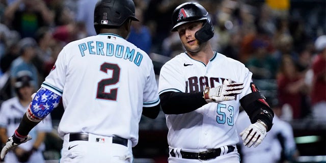 Arizona Diamondbacks' Christian Walker (53) celebrates his three-run home run against the San Francisco Giants with Diamondbacks' Geraldo Perdomo (2) during the third inning of a baseball game Tuesday, July 26, 2022, in Phoenix.