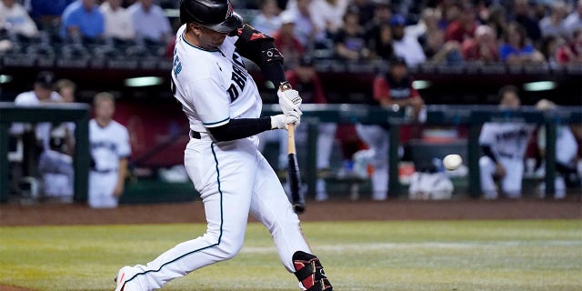 Arizona Diamondbacks' Christian Walker starts his swing on a three-run home run against the San Francisco Giants during the third inning of a baseball game Tuesday, July 26, 2022, in Phoenix.