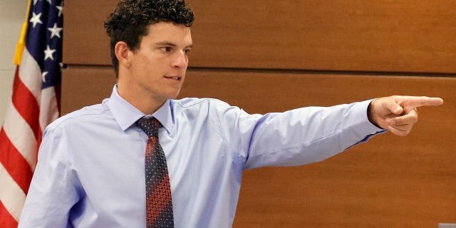Former Marjory Stoneman Douglas student Christopher McKenna points out Nikolas Cruz in the Broward County Courthouse in Fort Lauderdale, Fla., on Tuesday, July 19, 2022.