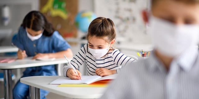 child taking a test with a mask