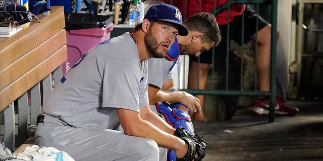 Los Angeles Dodgers starting pitcher Clayton Kershaw sits in a dugout during the sixth inning of a game against the Los Angeles Angels on July 15, 2022 in Anaheim, California.