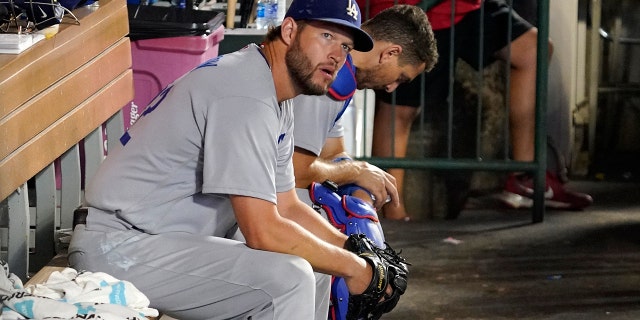 Los Angeles Dodgers starting pitcher Clayton Kershaw sits in the dugout during the sixth inning of a game against the Los Angeles Angels July 15, 2022, in Anaheim, Calif.